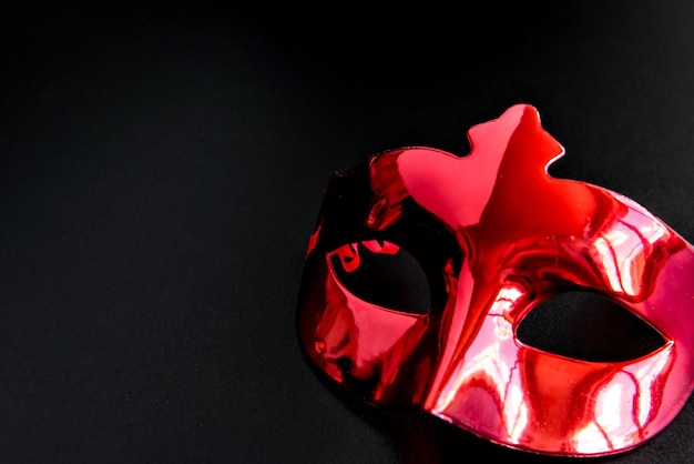 Brazilian carnival concept, carnival  red mask on black background.