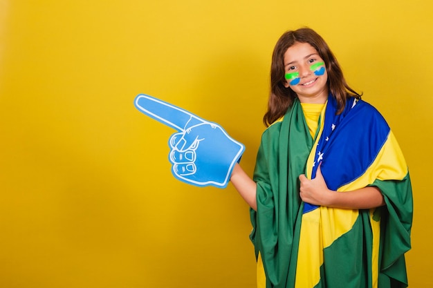 Brazilian caucasian child soccer fan pointing to the side advertisement promotion advertisement World Cup Olympics