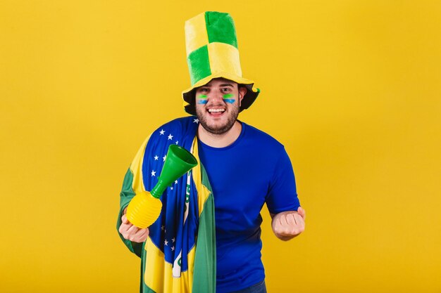 Brazilian caucasian man soccer fan from Brazil wearing hat