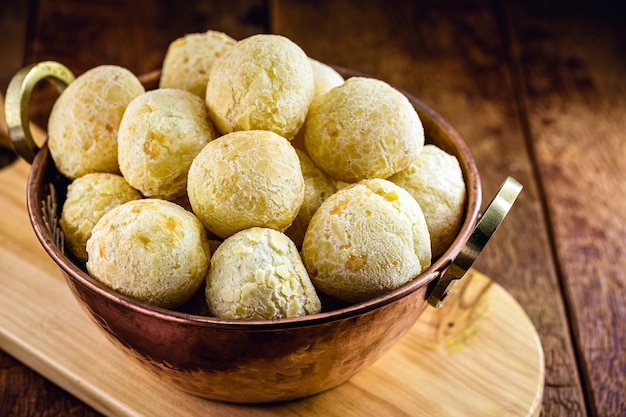 Brazilian cheese bread, typical food from the state of Minas Gerais, served in an old copper pot