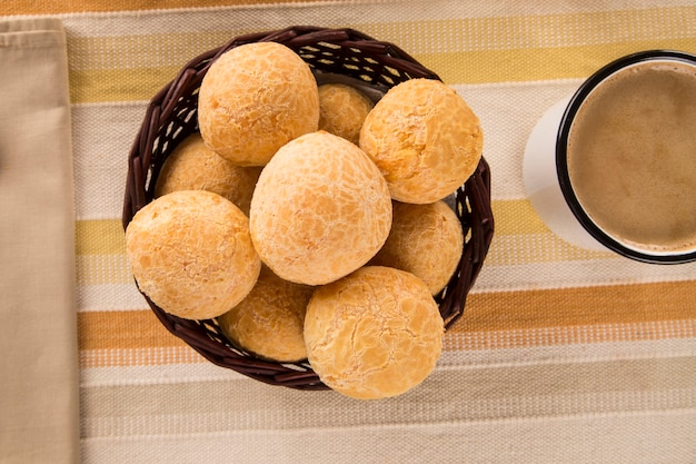 Brazilian cheese buns . Table cafe in the morning with cheese bread and fruits.