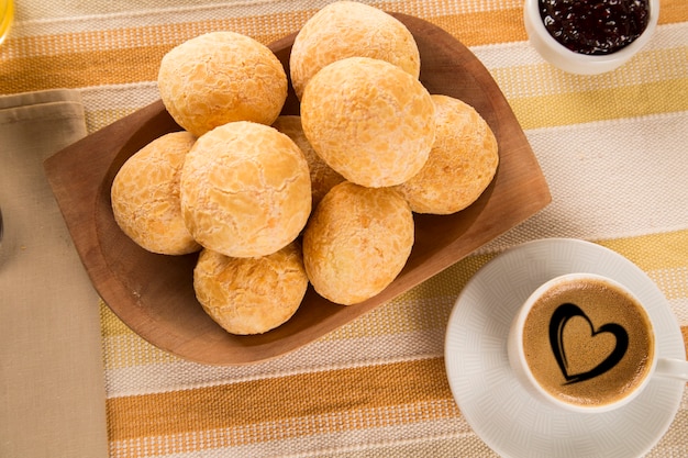 Brazilian cheese buns . table cafe in the morning with cheese bread and fruits.