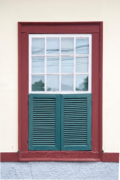 Brazilian colonial house window in a blue wall, copy space