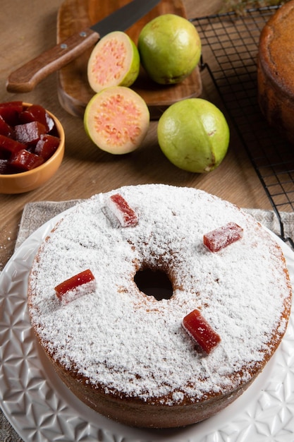 Brazilian corn cake made with a type of corn flour Fuba filled with guava paste On a wooden party table Typical sweets of the June festival Cornmeal cake