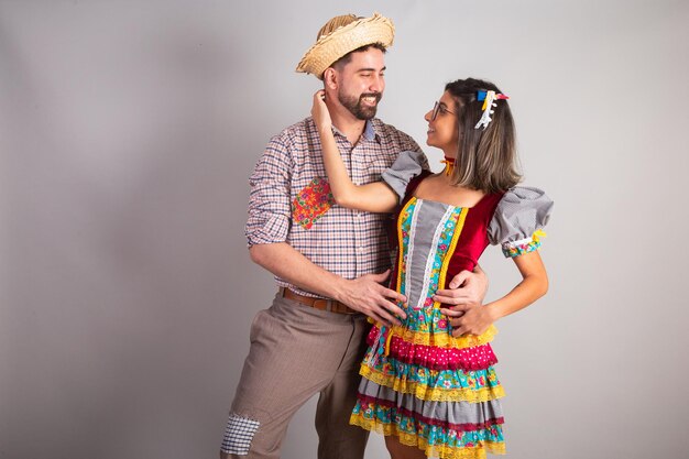 Brazilian couple dressed in festa junina clothes feast of Sao Joao embraced