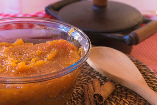 Brazilian dessert sweet of pumpkin coconut and cinnamon in a bowl and wood table