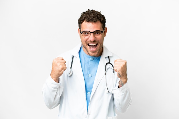 Brazilian doctor man over isolated white background celebrating a victory in winner position