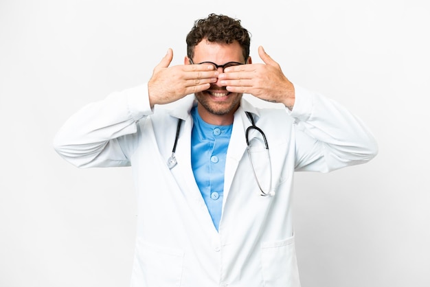 Brazilian doctor man over isolated white background covering eyes by hands