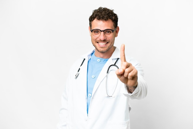 Brazilian doctor man over isolated white background showing and lifting a finger