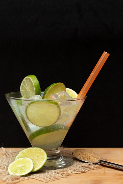 Brazilian drink caipirinha with sugar and ingredients around