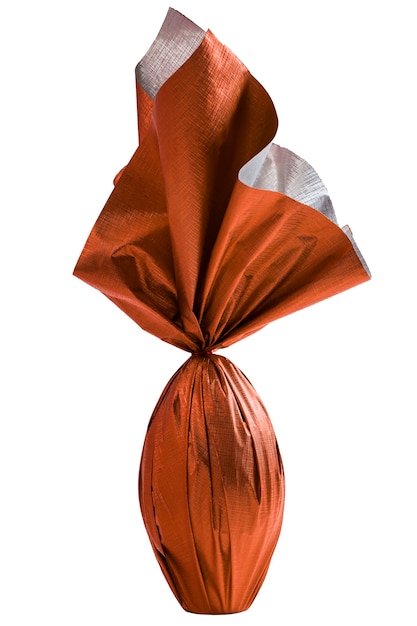 Brazilian Easters egg wrapped in orange paper on a white wall