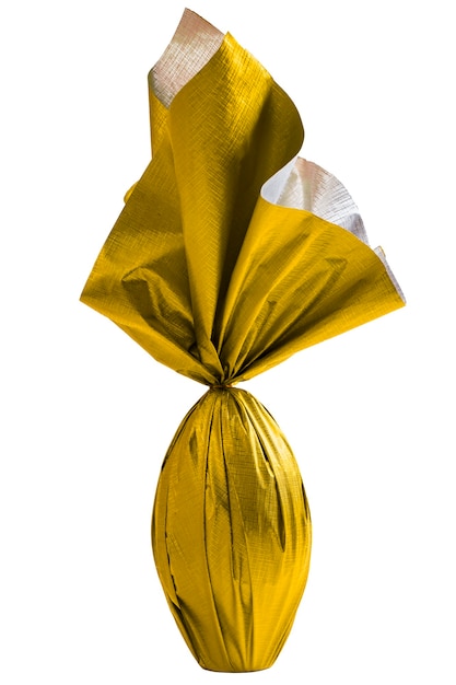 Brazilian Easters egg wrapped in yellow paper on a white wall