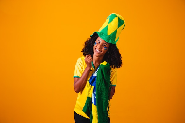 Brazilian fan. Brazilian fan celebrating football or soccer game. Colors of Brazil.