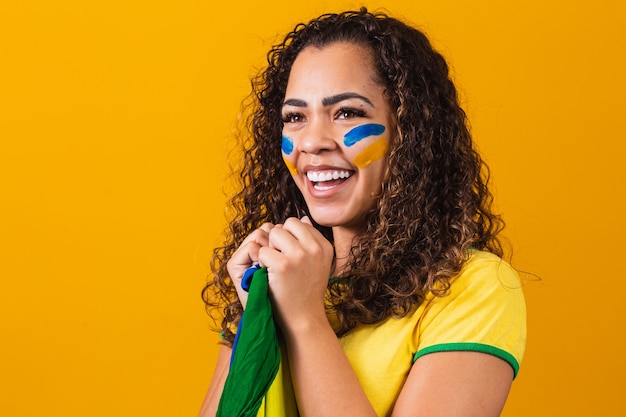 Tifoso brasiliano con la faccia dipinta di blu e giallo per la partita del brasile. brasiliano che celebra l'indipendenza del brasile. 7 settembre