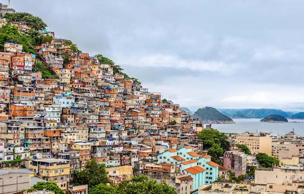 Brazilian favelas on the hill with city downtown below at the tropical bay Rio De Janeiro Brazil