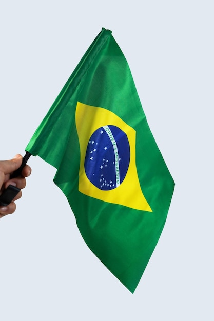 Brazilian flag flying Hand holding and waving flag. Selective focus Translation order and progress