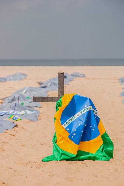 Brazilian flag on top of a cross during a demonstration against the Brazilian governments policy on coravirus at Copacabana beach in Rio de Janeiro