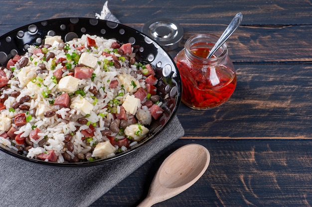 Brazilian food . Very common in the north of the country. Made with rice, beans, sausage and rennet cheese.