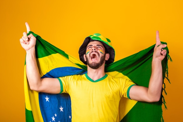 Brazilian football fan emotions celebrating excited happy Supporter of Brazil national soccer team is cheering