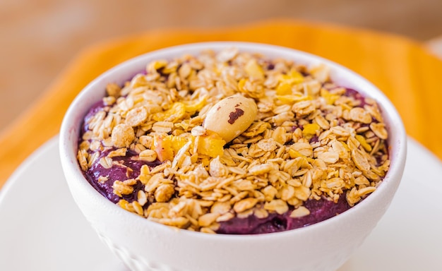 Brazilian frozen acai with granola in a white bowl