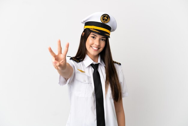 Brazilian girl Airplane pilot over isolated white background happy and counting three with fingers