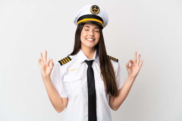 Brazilian girl Airplane pilot over isolated white background in zen pose