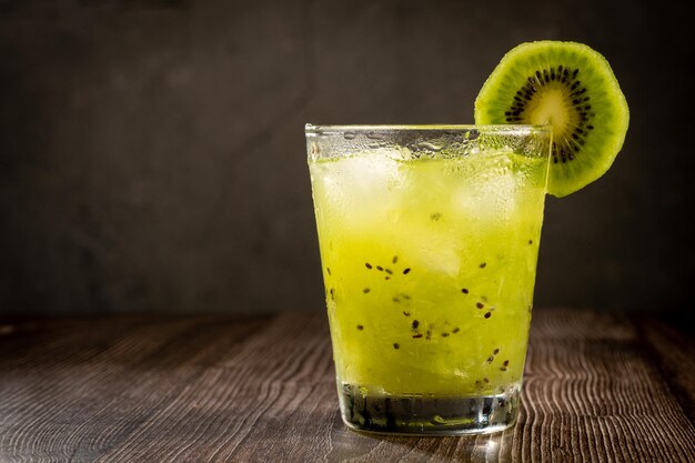 Brazilian Kiwi Caipirinha Cachaca drink with kiwi on wooden background