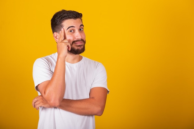 Brazilian Latin American man with hands on forehead and chin representing thought pensive