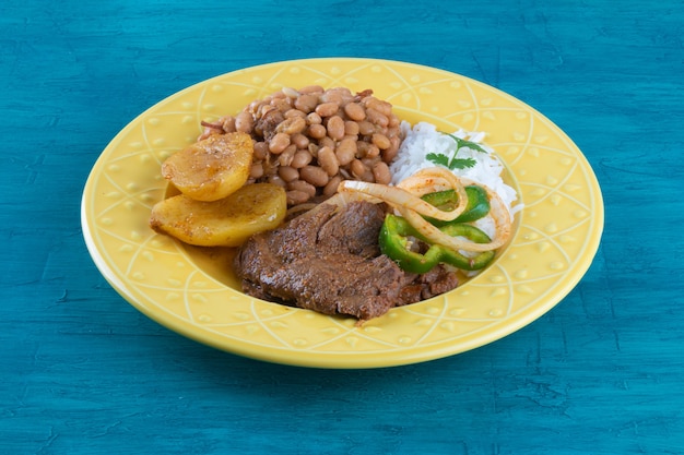 Brazilian lunch food dish with blue surface.