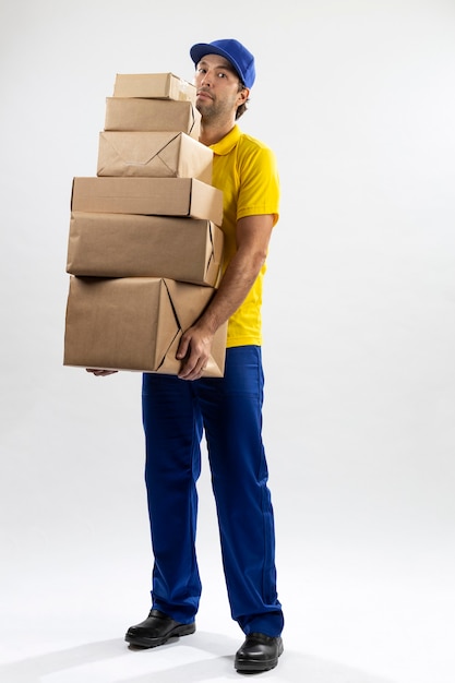 Brazilian mailman on a white background delivering a package. copy space.