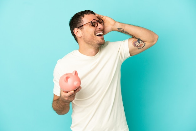 Brazilian man holding a piggybank 