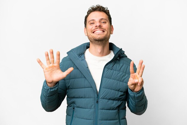 Brazilian man over isolated white background counting eight with fingers