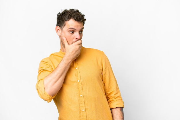 Brazilian man over isolated white background doing surprise gesture while looking to the side