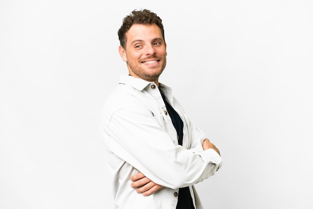 Brazilian man over isolated white background looking to the side and smiling