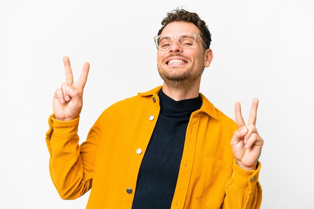 Brazilian man over isolated white background showing victory sign with both hands