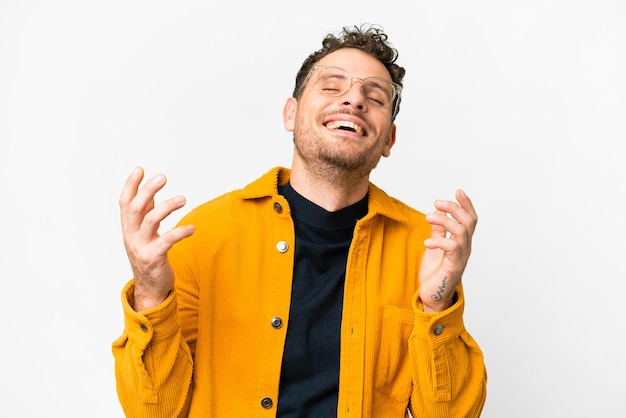 Photo brazilian man over isolated white background smiling a lot