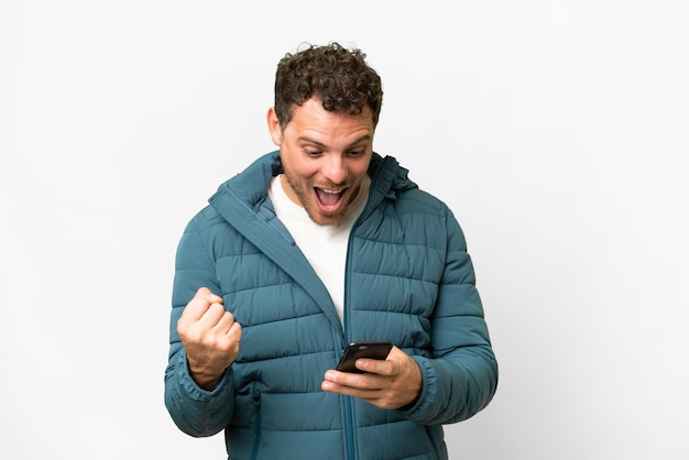 Brazilian man over isolated white background surprised and sending a message