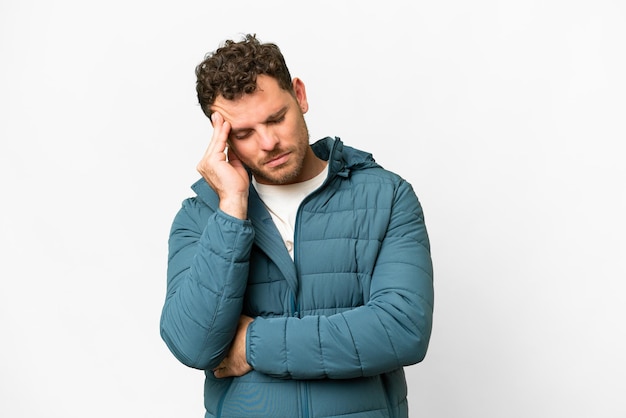 Brazilian man over isolated white background with headache