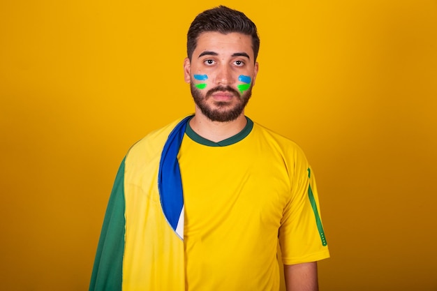 Brazilian man latin american cheering for brazil in the world cup 2022 Patriot nationalist looking at synonym of patriot seriousness competence happiness and joy