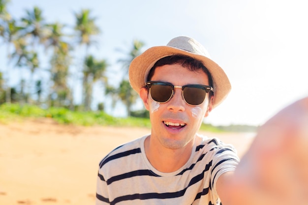 brazilian man taking a selfie on a paradisiacal beach vacation joy