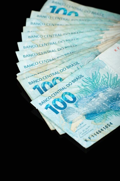 Brazilian money One hundred reais banknotes with black background finance concept