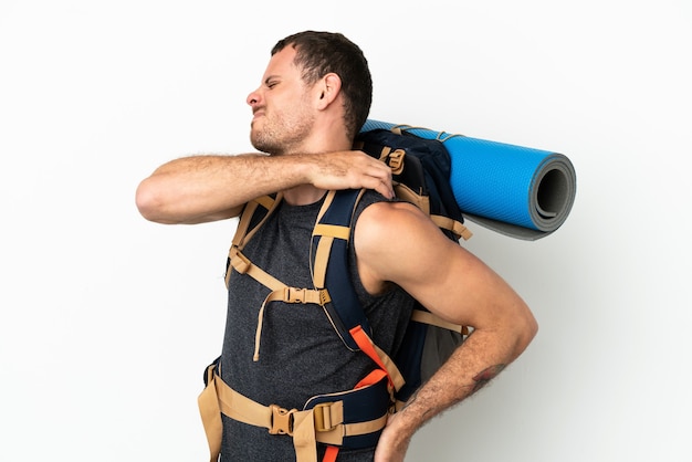 Brazilian mountaineer man with a big backpack over isolated white background suffering from pain in shoulder for having made an effort