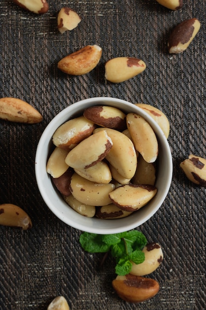 Brazilian nuts in a bowl on a wooden table