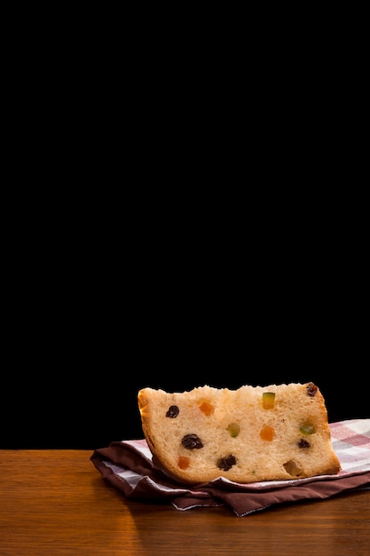 Brazilian panettone, a traditional pastry in Brazilian with a black background.