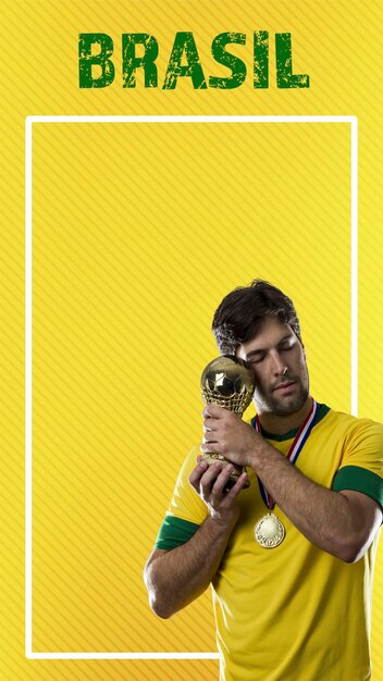 Brazilian player man celebrating on a yellow background