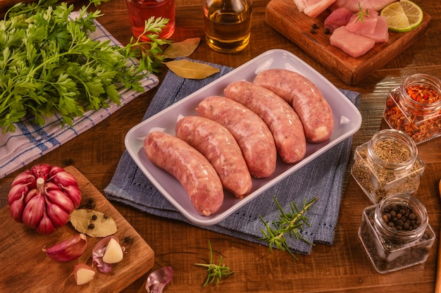 Brazilian pork leg sausage on white plate with spices and ingredients