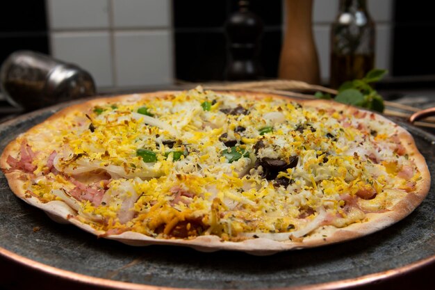 Brazilian Portuguesestyle pizza with ham egg pepper onion mozzarella top view