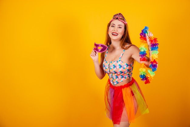 Brazilian redhead in carnival clothes with a mask and a flower necklace