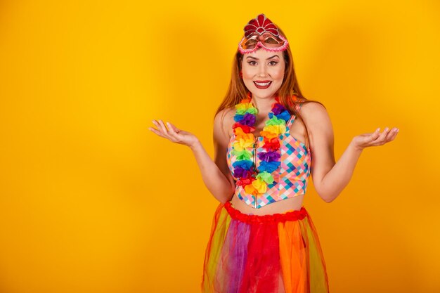 Brazilian redhead in carnival clothes with a necklace of flowers around her neck open arms welcome