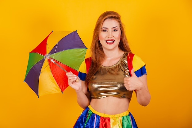Brazilian redhead with carnival clothes frevo and colorful parasol like thumbs up positive